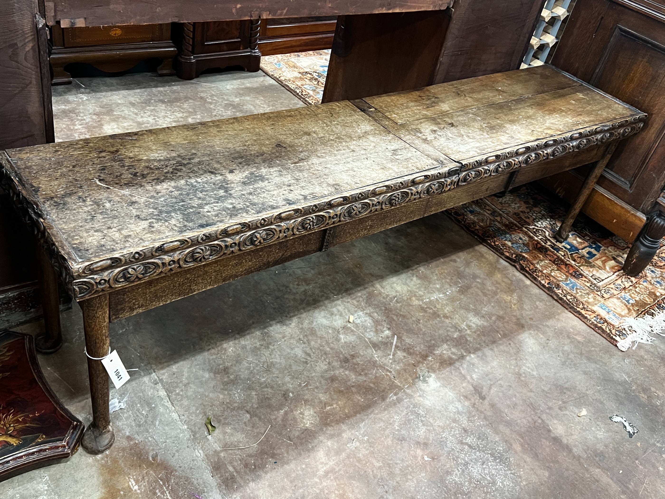 An 18th century and later carved oak hall bench with twin hinged box seat, width 183cm, depth 40cm, height 55cm